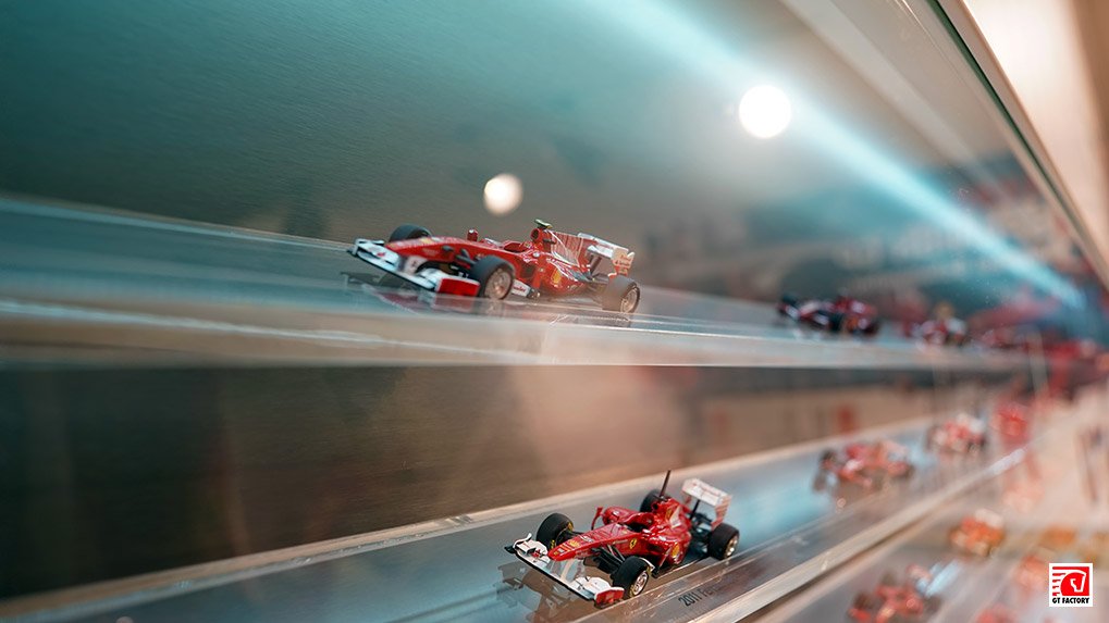 Wall of Ferrari race car scale models in chronological order