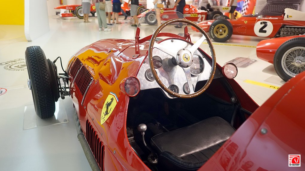 Historic Ferrari race car cockpit on display in Maranello