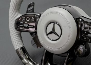Signature steering wheel with white leather, forged carbon fiber, and black gloss trim