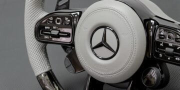 Signature steering wheel with white leather, forged carbon fiber, and black gloss trim