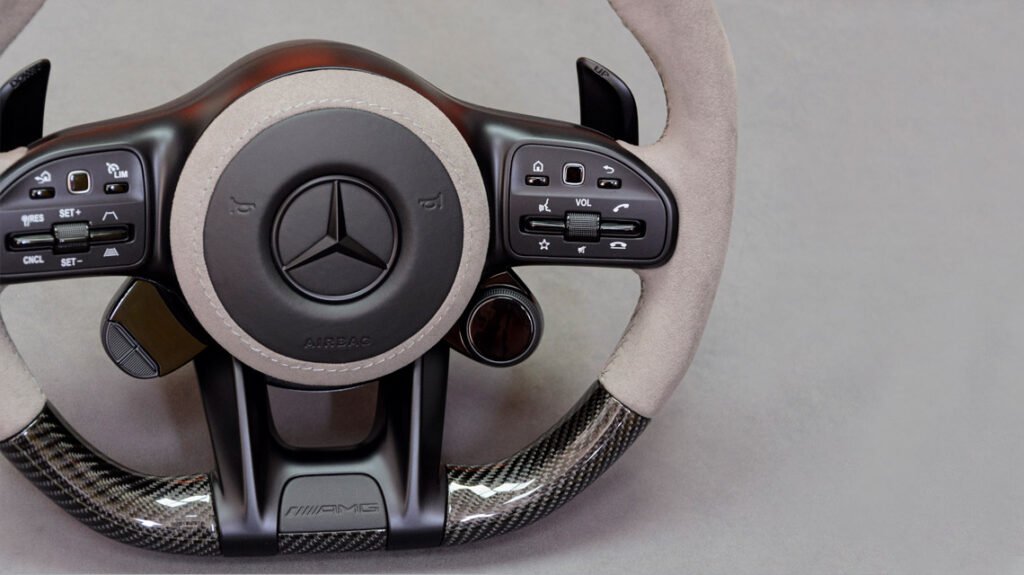 Mercedes-AMG G63 custom steering wheel with grey Alcantara, black hub, and carbon fiber trim