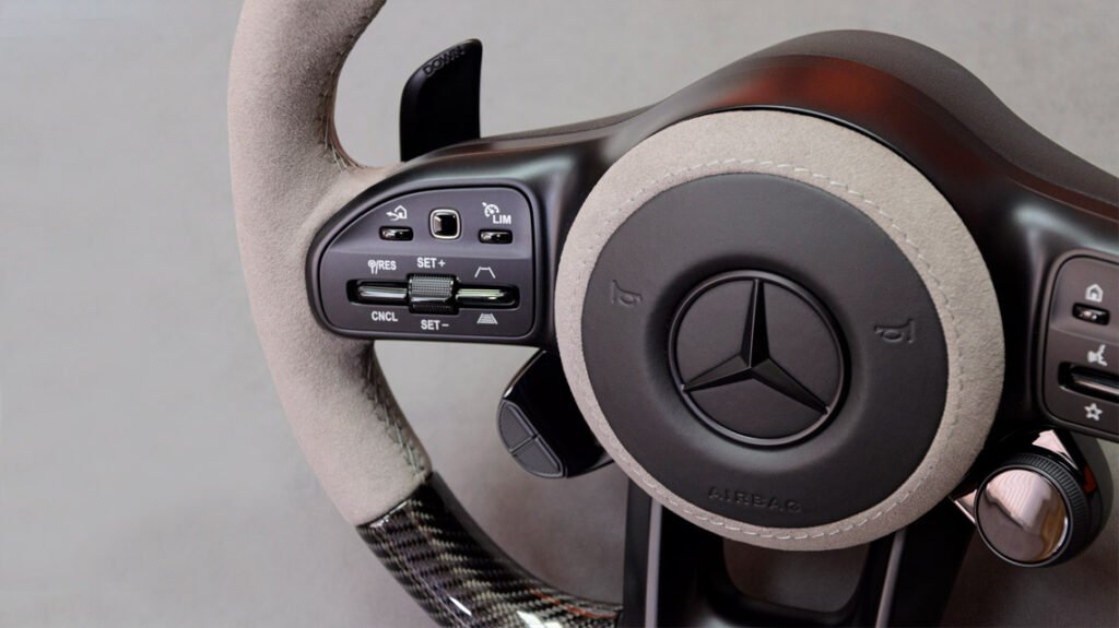 Close-up of Mercedes-AMG G63 bespoke steering wheel controls and grey Alcantara hub